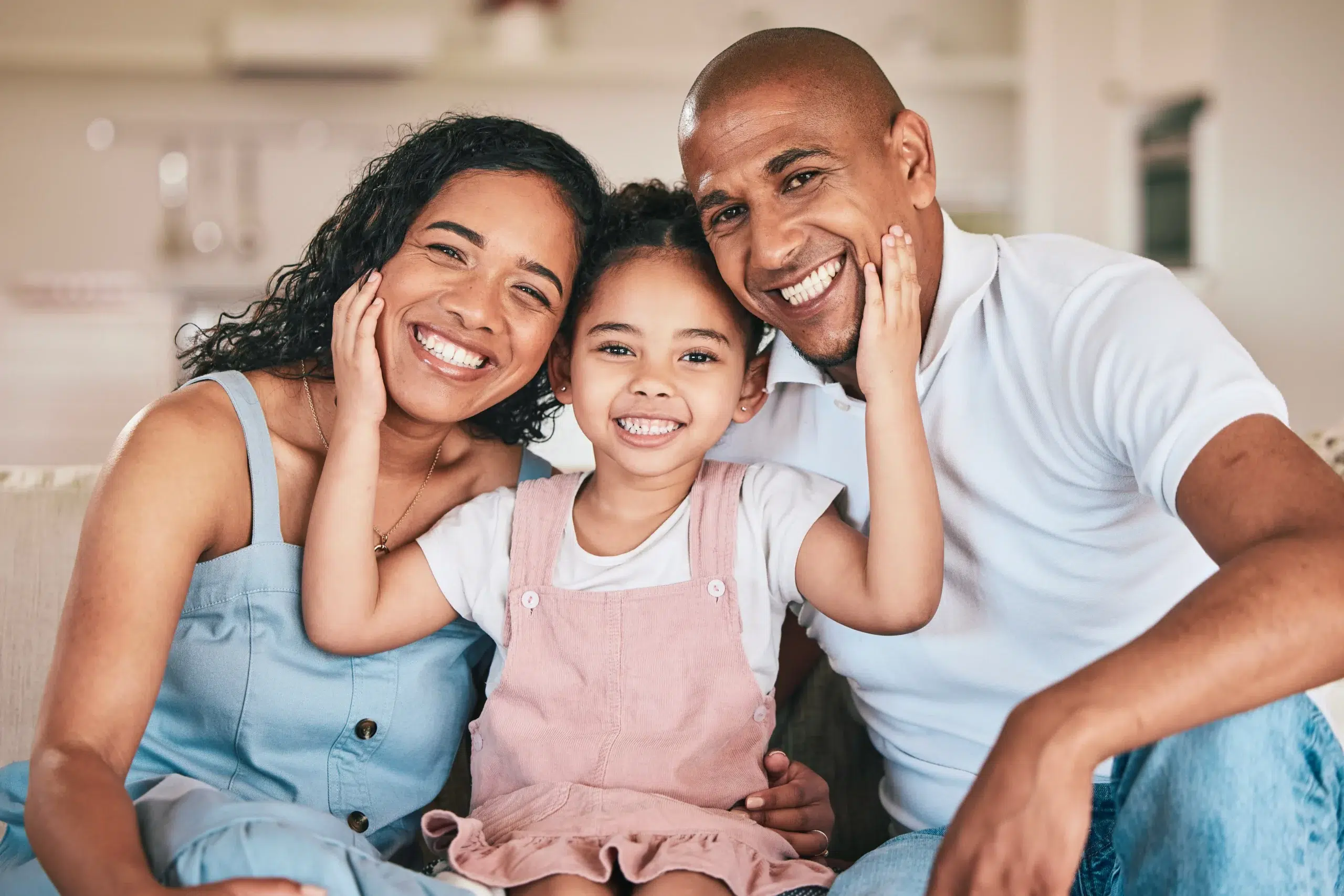Smiling parents with their young daughter