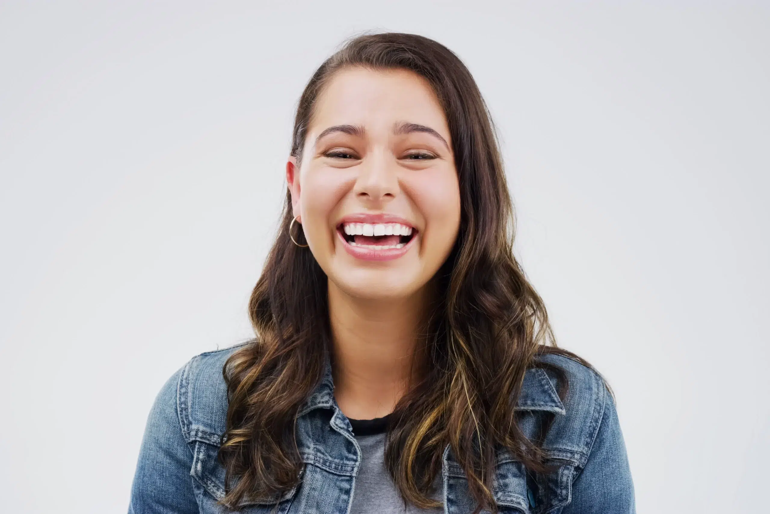 Laughing young woman in a denim jacket